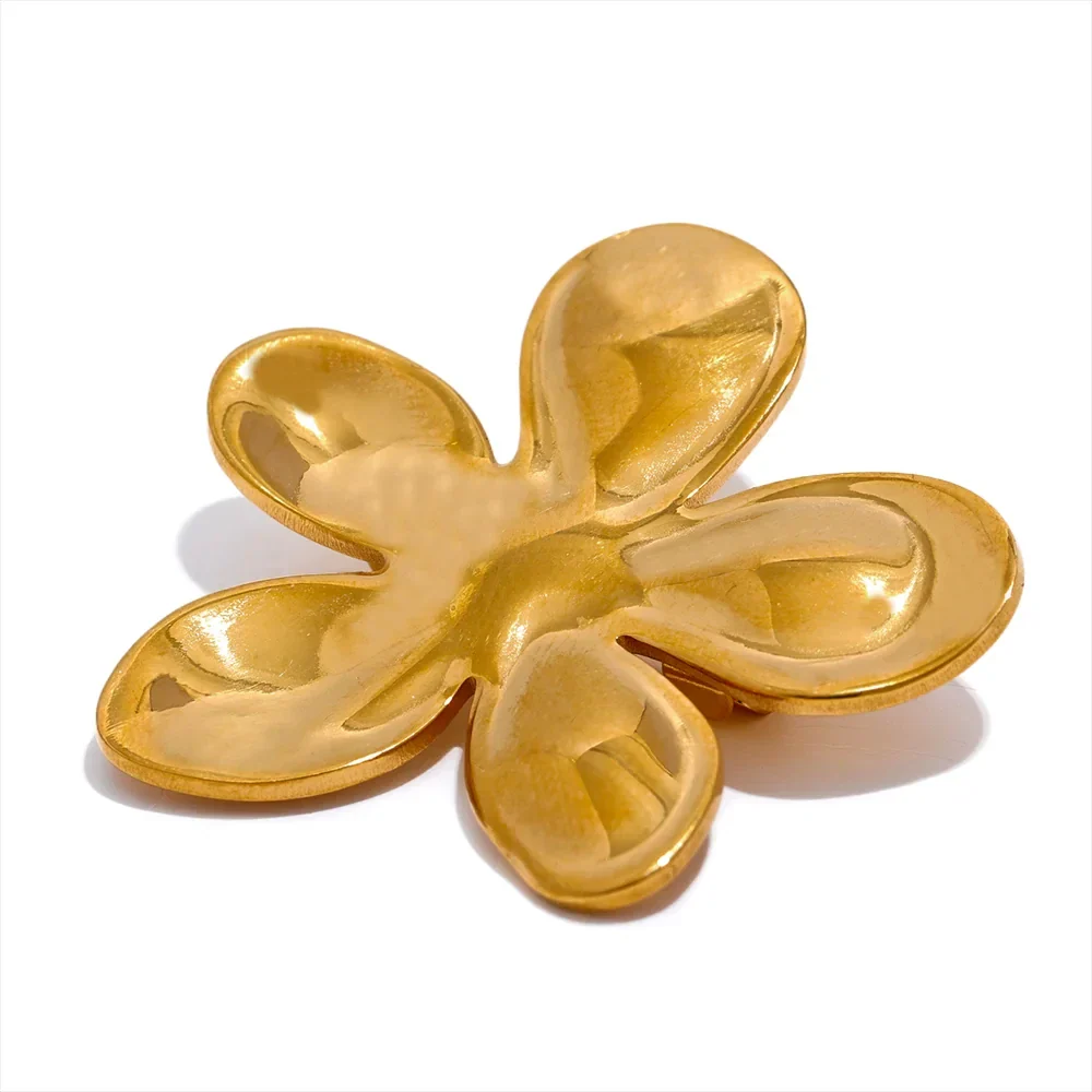 Gold bee brooch with crystal-studded black and yellow body and translucent white wings on peach fabric