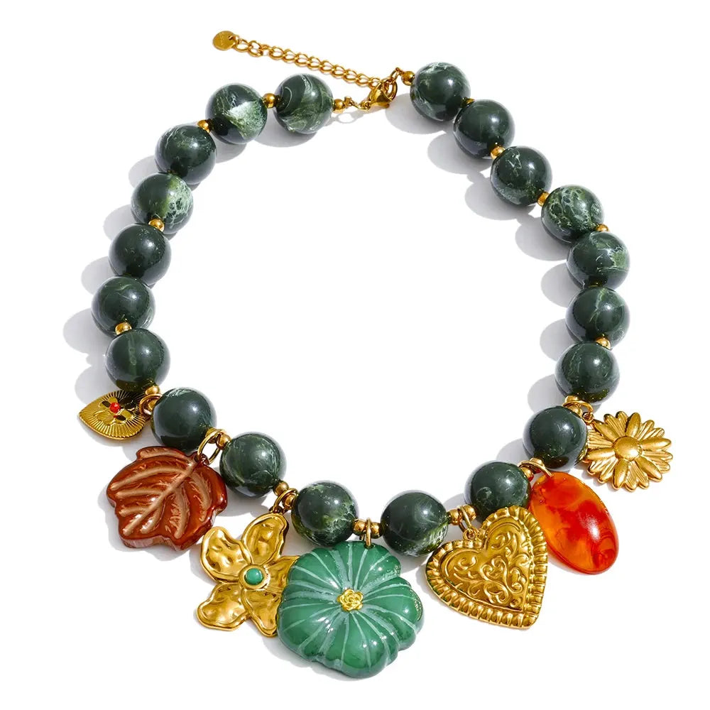 Statement Pieces jewelry: gold and silver chain bracelets with pearls on a textured rock.